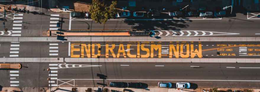 roadway with end racism now title in town